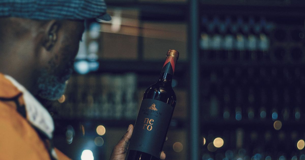 Expensive Wine in South Africa - Man holding up a bottle of Nero